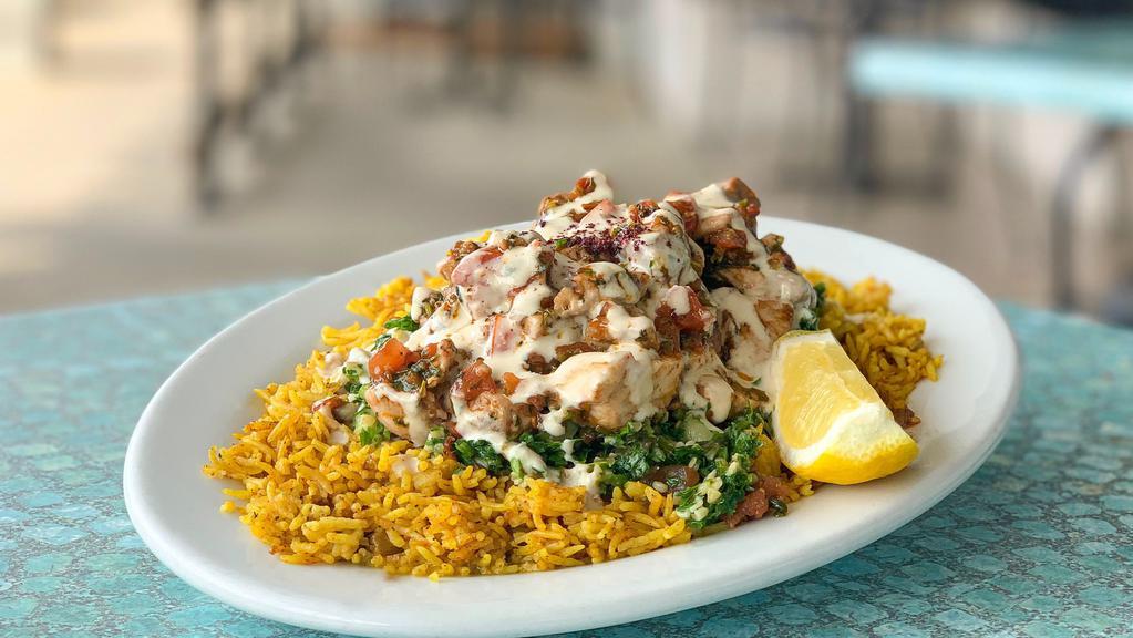 Spicy Seafood Platter (Lunch) · Spicy. Fresh pieces of the catch of the day, grouper and tuna sauteed in lemon olive oil, minced garlic, fresh cilantro, diced tomatoes, diced jalapenos, and spices. Served over a bed of basmati rice, tabbouleh salad and topped with tahini sauce.