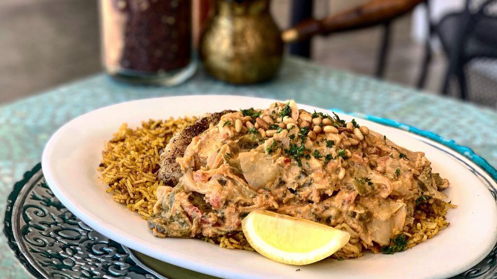  Grouper With Mild Spicy Tahini Sauce (Lunch) · Pan seared fillet of grouper topped with spicy tahini sauce and diced tomatoes, shredded carrots, garlic, julienne bell peppers and onions, cilantro and Tahini. Served over a bead of basmati rice and garnished with toasted pine nuts.