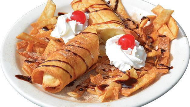 Banana Chimichanga · A fresh banana wrapped in a flour tortilla, deep-fried and sprinkled with cinnamon sugar. Topped with whipped cream, chocolate syrup, honey, and a cherry.