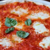Regina Margherita Pizza · Tomato sauce, fresh buffalo mozzarella, EVOO and fresh basil garnish.