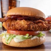 Bacon Ranch Chicken Sandwich · Fried chicken sandwich with bacon, cheese,  tomato, lettuce, and ranch on a bun.