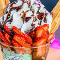 Churro Sundae · Churro, ice cream, strawberry, almonds, whipped cream, chocolate drizzle.