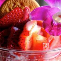 Strawberry Colado · Shaved ice strawberry drink, topped w/ strawberries, lechera, edible flower, maria cookie.
