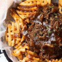 Debris Fries · Slow-cooked roast beef, shredded cheddar, queso