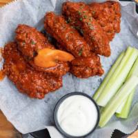 Chicken Wings · Crispy fried and tossed in buffalo, served with ranch or blue cheese & celery