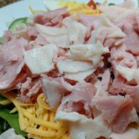 Chef Salad · Turkey, ham and cheddar cheese served on a bed of our salad mix with tomatoes, green peppers...