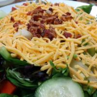 Garden Salad · Our crisp salad mix served with tomatoes, green peppers, onions, cucumbers, and cheddar chee...