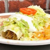 Burrito Supreme · Burrito stuffed with your choice of chicken or beef; topped with lettuce, sour cream and shr...