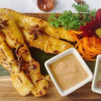 Satay (4 Skewers) · Sliced chicken marinated in coconut milk charbroiled and served on a skewer with peanut sauce.
