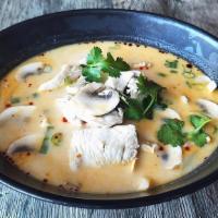 Tom Kha (Bowl) · Coconut milk with lime juice, galangal, and Thai herbs.
