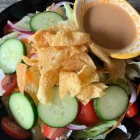 Thai Salad · Lettuce, tomatoes, onions and cucumbers, topped with peanut sauce dressing.