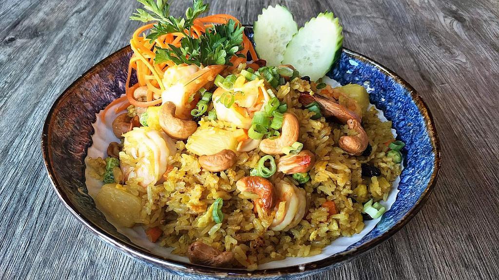 Pineapple Fried Rice · Fried rice with curry powder, raisins, carrots, peas, and cashew nuts.