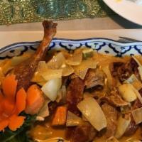 Panang Duck · Crispy duck topped with Panang curry,
Thai basil and kaffir lime leaves