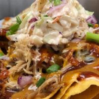 Bbq Nachos · Layered crisp tortilla chips loaded with pulled pork, Jack cheese, jalapeno peppers, black b...