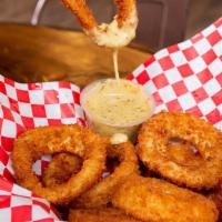 Onion Rings · A Basket of Crispy Golden Onion Rings served with a side of Honey Mustard