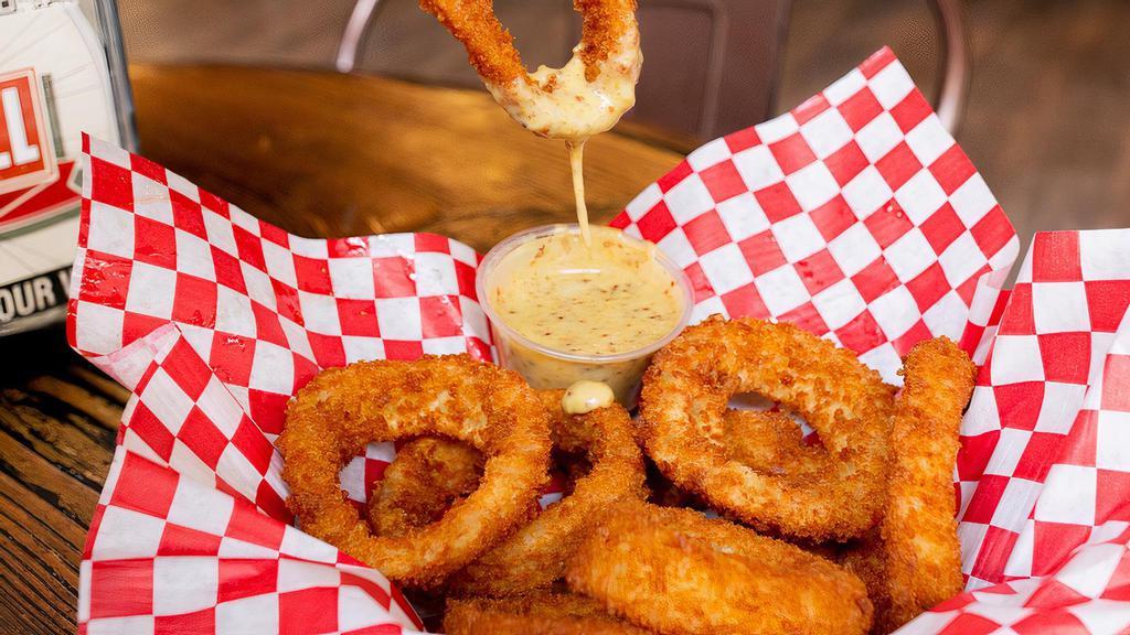 Onion Rings · A Basket of Crispy Golden Onion Rings served with a side of Honey Mustard