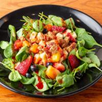 Skinny Spinach Salad · Spinach, pineapple, cantaloupe, strawberries, crunchy granola, almonds, goat cheese, fat-fre...