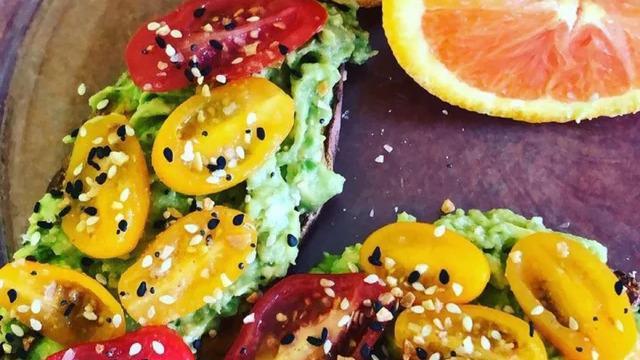 Avocado Toast · Ripe avocado smashed with lemon juice, pink salt and cracked pepper over sourdough toast, topped with heirloom cherry tomatoes and sprinkled with everything seasoning.