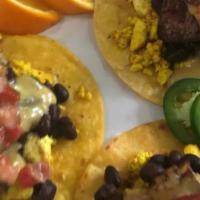 Breakfast Tacos · Gluten Free. Tofu scrambles, roasted potatoes, seasoned black beans smothered with vegan que...