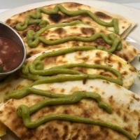 Spicy Spinach Quesadilla · Organic spinach with onions and garlic in a spicy vegan pepper jack cheese toppped with avoc...