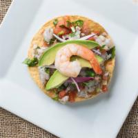 (1) Tostada De Ceviche · Raw Shrimp or steamed Tilapia cured in lime juice served with tomato, onion, and cerano pepp...