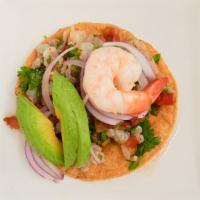 (1) Tostada De Ceviche · Raw Shrimp or steamed Tilapia cured in lime juice served with tomato, onion, and cerano pepp...