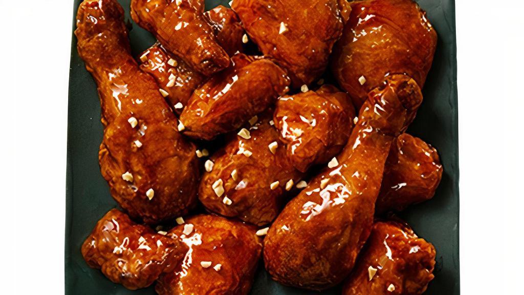 Gangjeong Wings · A soy derived sauce with hints of cinnamon garnished with chilis to give a light spicy bite.
