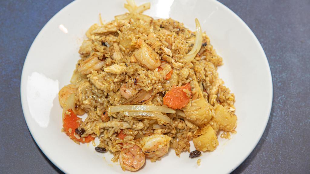 Pineapple Fried Rice · Spicy. Chicken and shrimp stir-fried with raisin, onions, egg, carrots and hint of curry with crushed peanut.