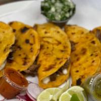 Taco Birria  · The order is 4 tacos hand made corn tortillas, chesse, cilantro and onion with side hot sauc...