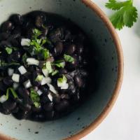 Black Beans · Black beans with jalape�os, yellow onion + tomatoes