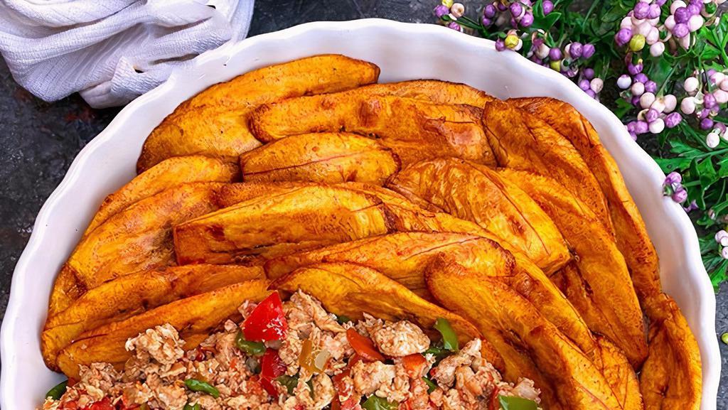Plantain / Sweet Potato With Egg Stew · Eggs fried omelette style with peppers and sliced bread.