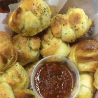Garlic Knots · Fresh baked hand-knotted dough smothered in a buttery blend of Italian spices, garlic, and P...