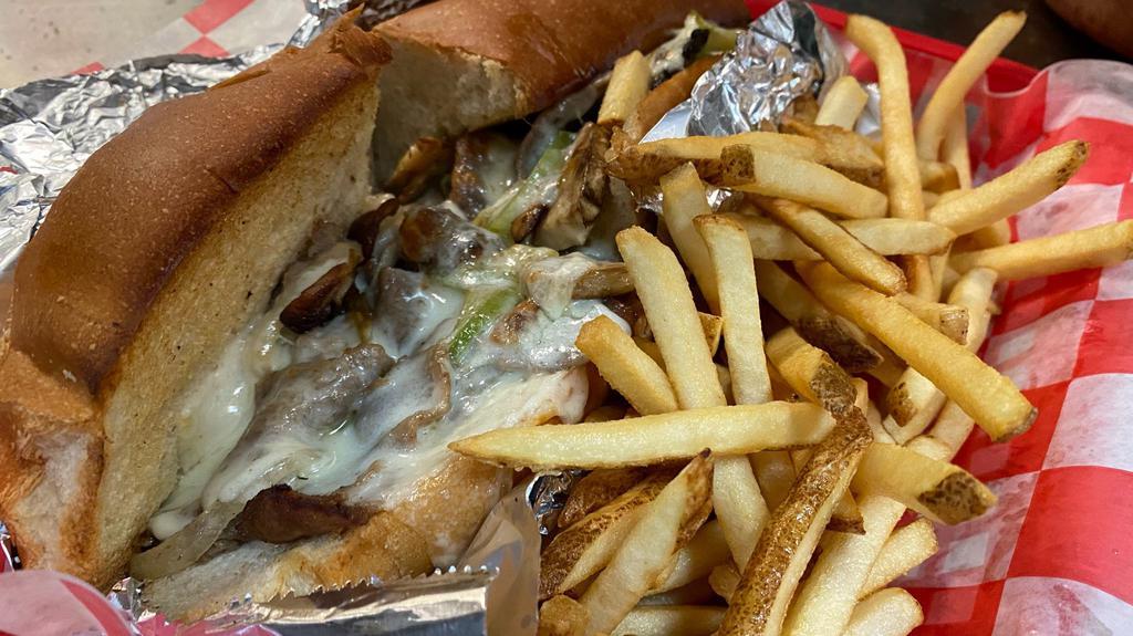 Philly Cheesesteak · Thinly sliced steak sautéed with green pepper, onion and mushrooms, topped with mozzarella cheese and baked to perfection. Served with chips or fries