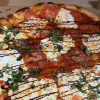 Margherita Pizza · Red sauce, fresh mozzarella, fresh tomato and fresh basil, drizzled with balsamic glaze