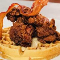 Chicken N Waffles · Bacon infused waffle, fried chicken thigh, sausage gravy, bourbon maple syrup, candied bacon
