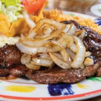 Mp- Beef Steak A La Tampiquena · 8oz. ribeye steak topped with grilled onions. Served with Mexican rice, refried beans, and g...