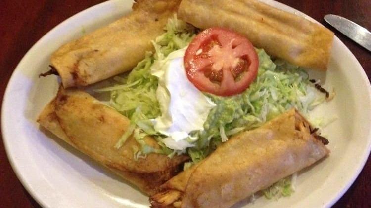 Chimichanga · Fried or soft tortilla filled with chicken or beef, topped with white queso, red sauce, lettuce, sour cream, guacamole, tomato, rice and beans.