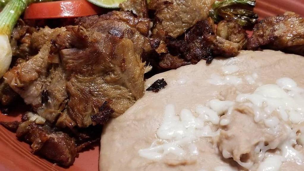 Carnitas · Deep fried, seasoned pork chunks served with rice beans, tomatillo sauce and tortillas.