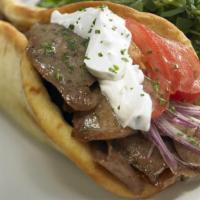 Rotisserie Gyro (Beef & Lamb) · Topped with original tzaziki sauce, tomatoes, onion lettuce, served on an authentic gyro bre...