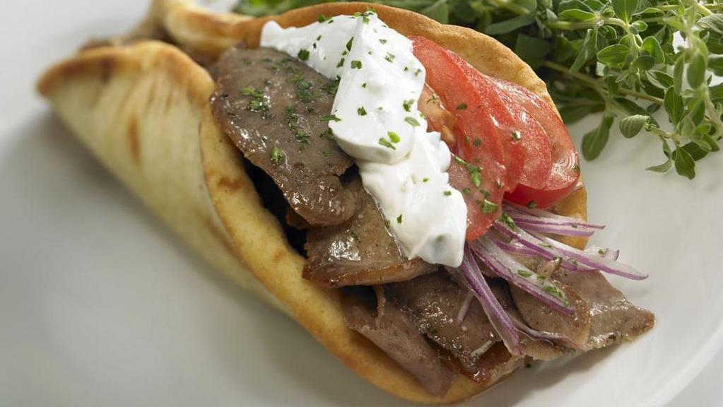 Rotisserie Gyro (Beef & Lamb) · Topped with original tzaziki sauce, tomatoes, onion lettuce, served on an authentic gyro bread.