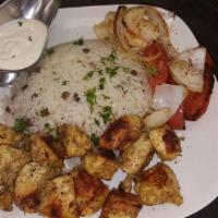 Chicken Kebab Plate · On a bed of rice, with grilled veggies, plus greek salad and garlic sauce.