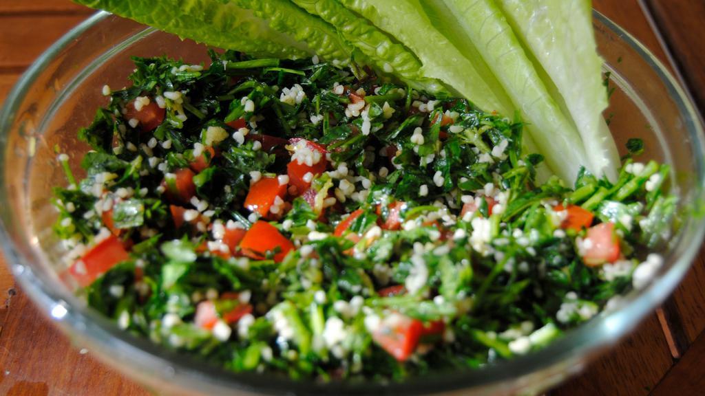 Tabbouleh Salad · A healthy mediterranean salad consisting of chopped parsley, bulgur wheat, diced tomatoes. Seasoned with extra virgin olive oil, fresh squeezed lemon juice,