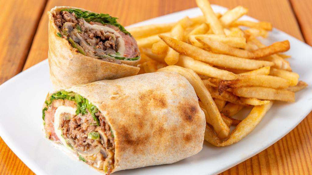 Steak Philly Wrap · Grilled with onions, green peppers, and mushrooms, shredded mozzarella cheese, mayonnaise, romaine, and tomato in a wheat wrap.