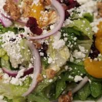 Goat Cheese · Romaine, walnuts, dried cranberries, oranges, onion tossed in shallot vinaigrette.
