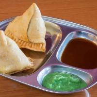 Vegetable Samosa · Deep fried crisp pastries stuffed with mildly spiced potatoes and peas. Served with savory s...