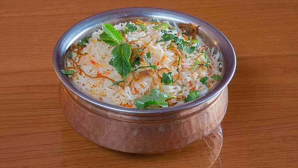 Goat Biriyani · Basmati rice with fresh cardamom, mint and saffron, and slow cooked in a sealed pot. Served with raita.
