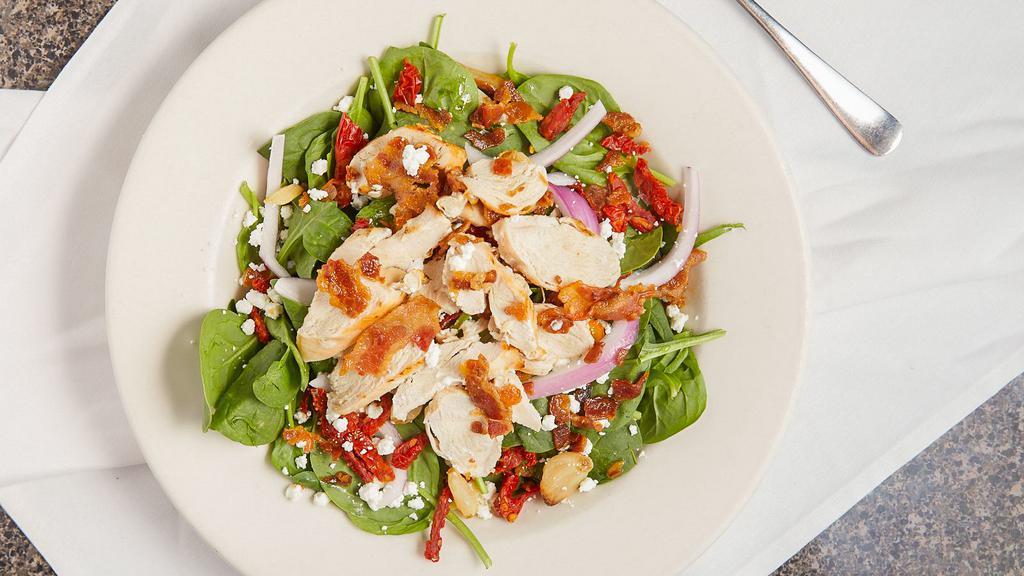 Grilled Chicken & Spinach · Spinach topped with roasted garlic, red onion, sun-dried tomatoes, bacon, croutons, goat cheese, and balsamic vinaigrette.