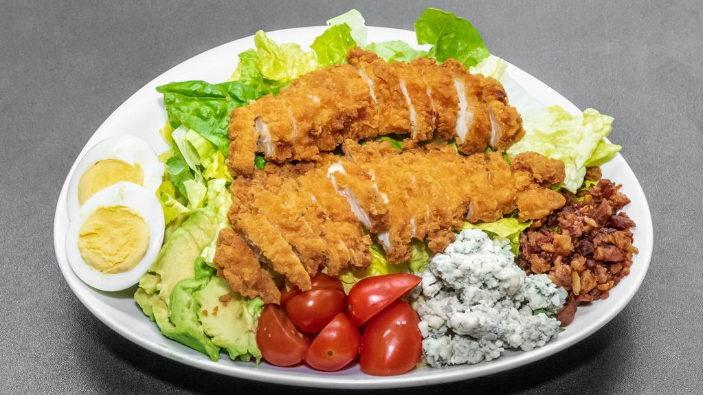 Fried Chicken Cobb Salad · Romaine lettuce topped with fried chicken, bacon, tomatoes, avocado, hard-boiled egg and blue cheese crumbles.
