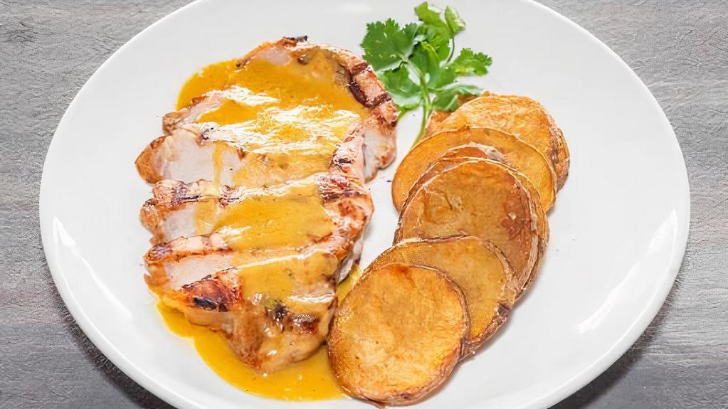 Pork Dijonnaise · Gluten-free. Grilled pork loin with Dijon mustard sauce. Served with skillet fried potatoes.
