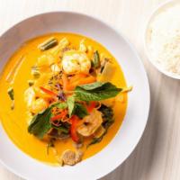 Kand Dang (Red Curry) · Thai famous red curry in coconut cream sauce with bamboo shoots, green beans, and Thai basil
